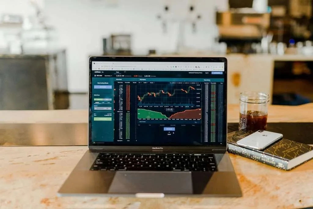 image of a laptop with trading stocks on the screen